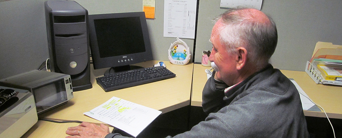 Man at desk on phone